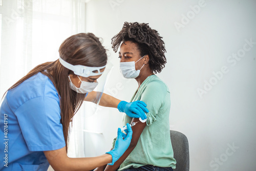 Woman with face mask getting vaccinated, coronavirus, covid-19 and vaccination concept. Corona Virus Protection, Cure And Medication. Selective Focus. photo