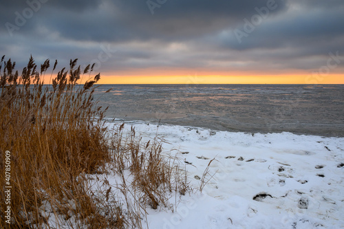Snow covered beach at sunset  winter landscape in Jastarnia on the coast of the Hel Peninsula. Poland