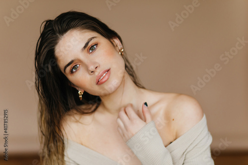 Happy pale girl posing on light background. Indoor portrait of inspired brunette lady.