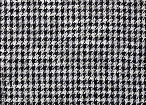 Fashionable fabric made of wool with pepita pattern in black and off-white, textile background image