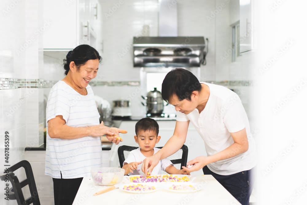 Multigeneration people in the family are happy to prepare and cooking the dessert in the kitchen with happy moment, concept of practical life learning for child through home based activity. Multigeneration people in the family are happy to prepare and cooking the dessert in the kitchen with happy moment, concept of practical life learning for child through home based activity.