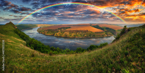 colorful rainbow over the river canyon. spring morning