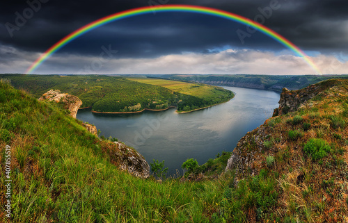 colorful rainbow over the river canyon. spring morning