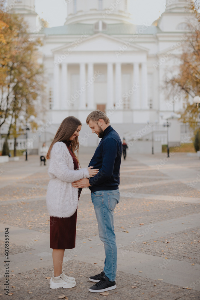 Young couple man and woman in the city landscape in the park Young couple man and woman in the city landscape in the park