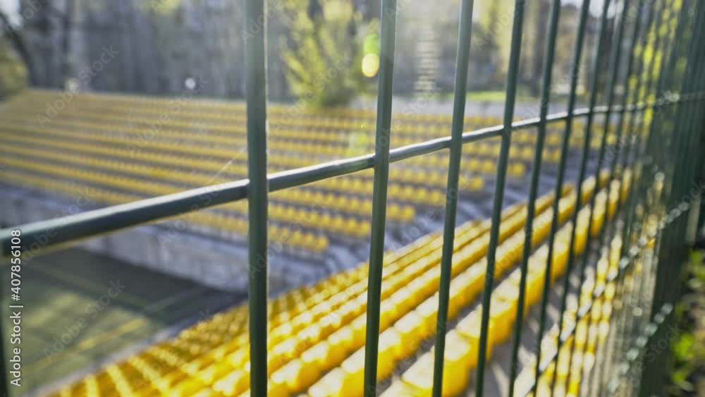 The stadium is fenced with an iron fence. Lockdown. Empty seats in the stadium without spectators and fans. Cancellation of matches due to the coronavirus pandemic, quarantine. Access is closed. The stadium is fenced with an iron fence. Lockdown. Empty seats in the stadium without spectators and fans. Cancellation of matches due to the coronavirus pandemic, quarantine. Access is closed.