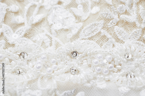 the texture of a wedding dress, embroidered with beads, rhinestones and sequins.