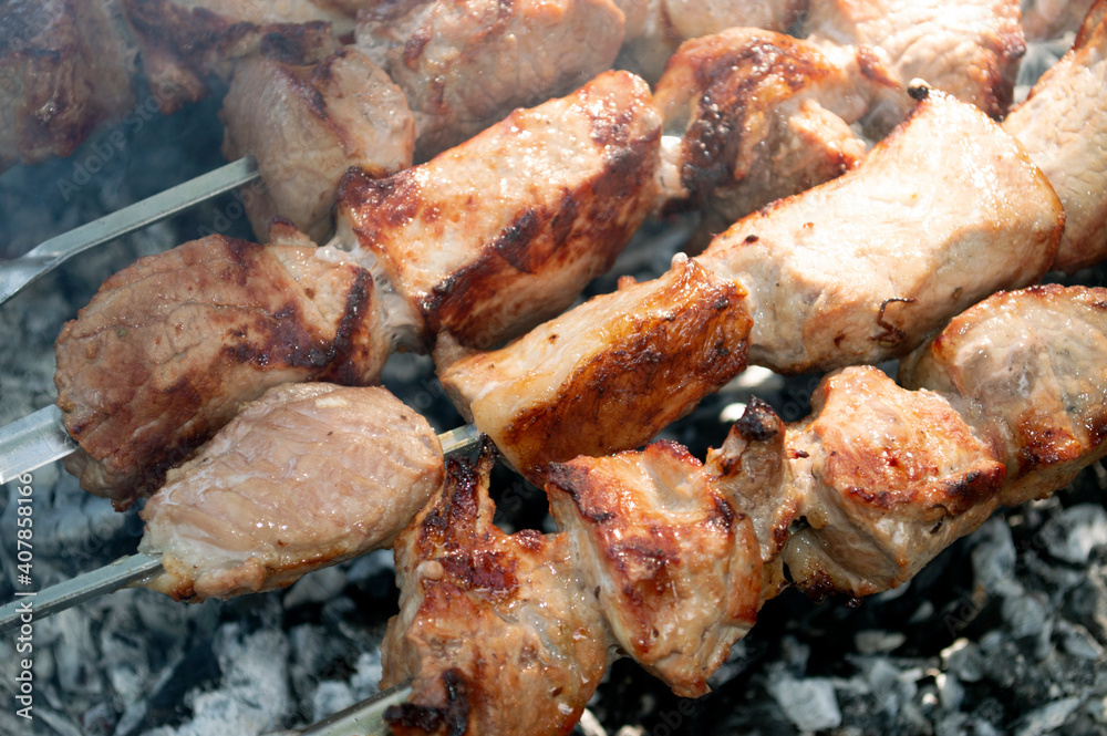 grilled pieces of meat on metal skewers