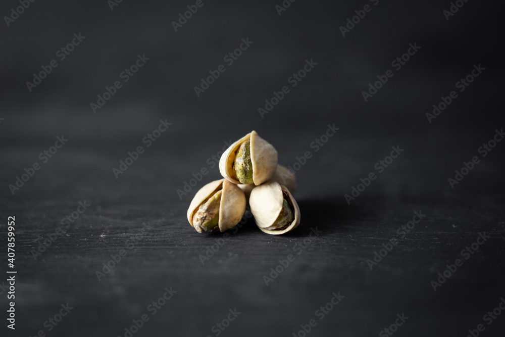 pistachios isolated in the middle on, black background pistachios isolated in the middle on, black background