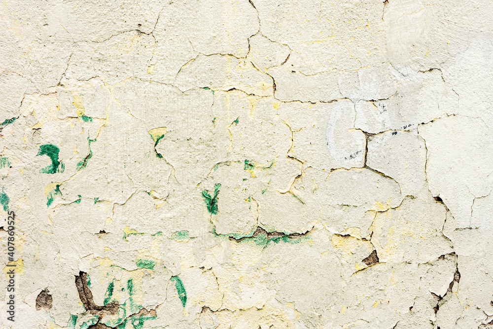 Cracked flaked shabby gray wall, old peeled white wall background