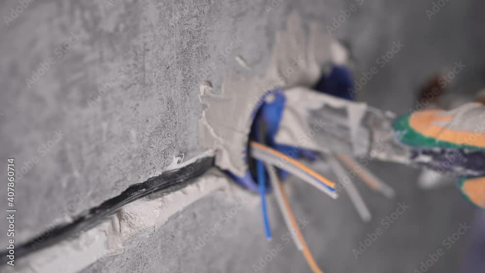 The man is covering a hole in the wall The man is covering a hole in the wall