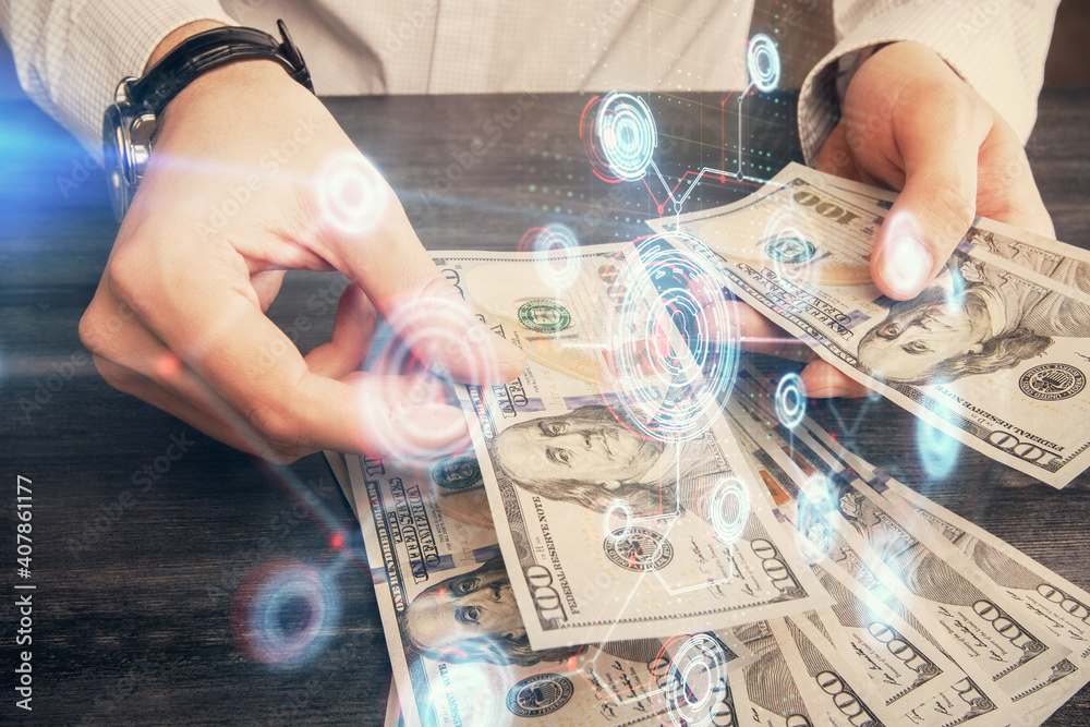 Double exposure of technology drawing hologram and us dollars bills and man hands. Data concept Double exposure of technology drawing hologram and us dollars bills and man hands. Data concept
