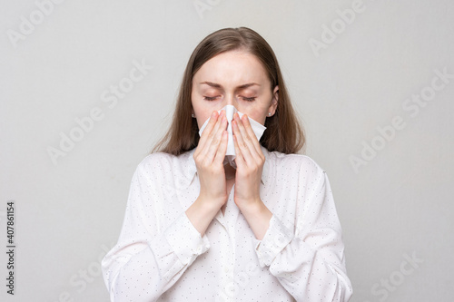 Wallpaper Mural Sick girl blowing nose into tissue, portrait, white background, closeup Torontodigital.ca