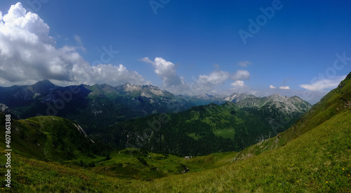 mountain valley with green hills and beautiful sky panorama
