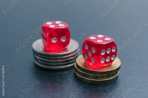 The dice lie on the chips or coins on the table in the casino