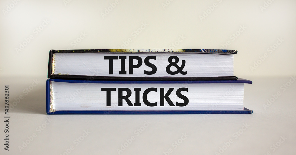 Tips and tricks symbol. Books with words 'Tips and tricks'. Beautiful white background. Business, tips and tricks concept. Copy space.