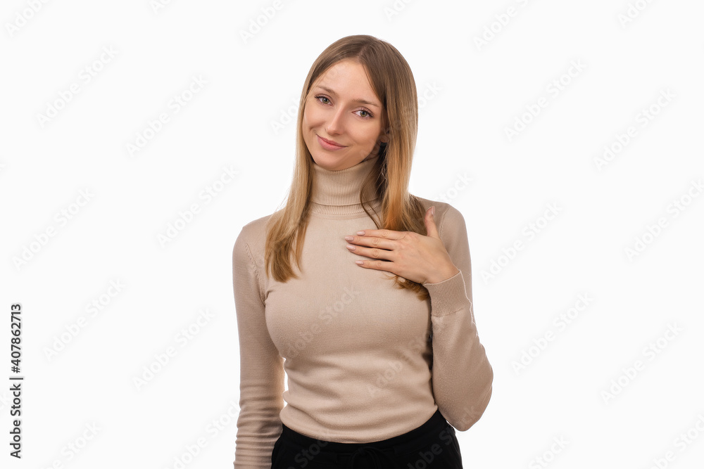 Pleasant young blond woman hold hands on heart thanking for compliments or praises. Studio shot, white background Pleasant young blond woman hold hands on heart thanking for compliments or praises. Studio shot, white background