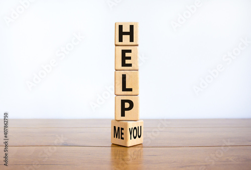 Help you or me symbol. Turned wooden cubes and changed words help me to help you. Beautiful wooden table, white background, copy space. Business, motivational and help you or me concept.