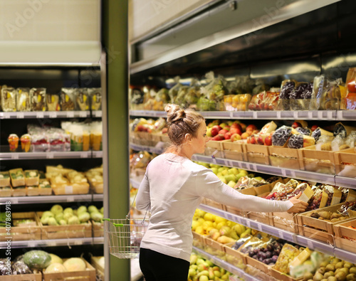 Woman buying fruits and vegetables at the market.