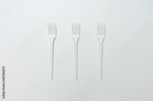 Top view of three plastic forks  white background  copy space