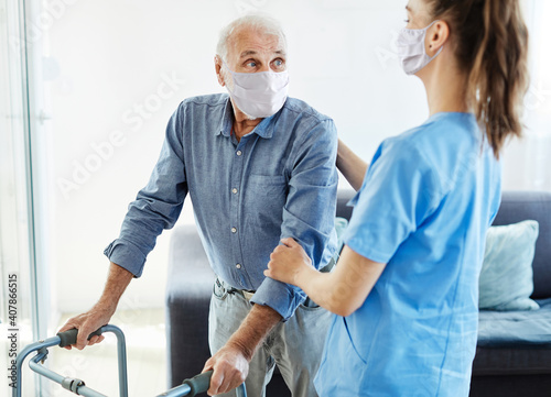 nurse doctor senior care caregiver help walker assistence retirement home nursing man virus mask corona photo