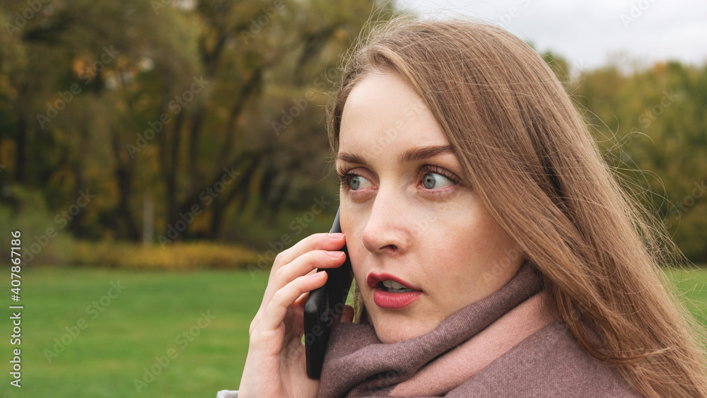 Shocked woman talking on the phone, girl walking down the street, portrait, close-up, 16:9 Shocked woman talking on the phone, girl walking down the street, portrait, close-up, 16:9