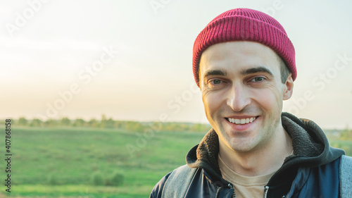 Pleased man on the background of a beautiful landscape, portrait, close-up, 16:9