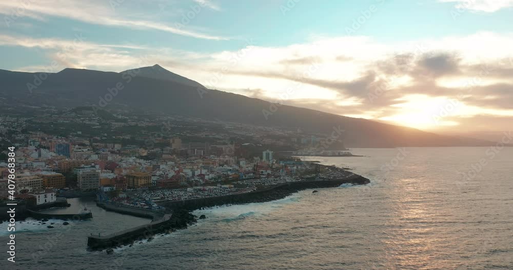 Aerial panorama of Puerto de la Cruz resorts and pools surrounded by sea waves on sunset, Tenerife, Canary islands, Spain. Aerial panorama of Puerto de la Cruz resorts and pools surrounded by sea waves on sunset, Tenerife, Canary islands, Spain.