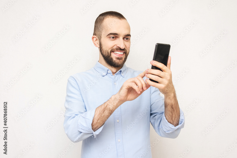 Bearded uses phone, white background, copy space Bearded uses phone, white background, copy space