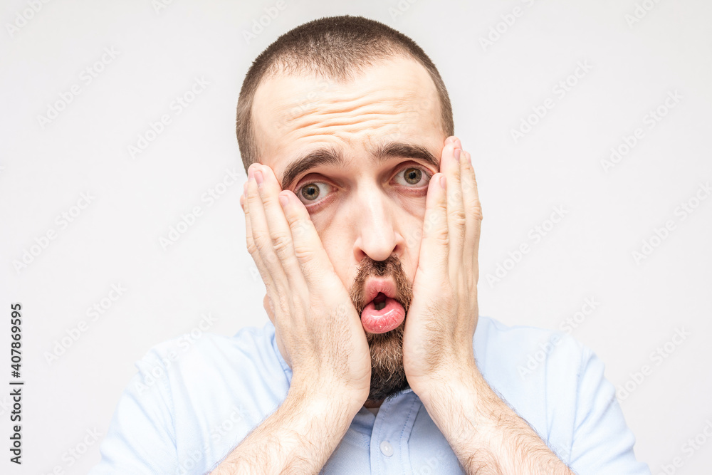 Man is very upset and puzzled, grimace of frustration on the face bearded man, close-up Man is very upset and puzzled, grimace of frustration on the face bearded man, close-up