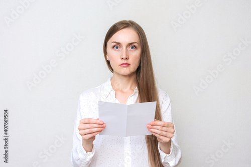 Excited woman reading a letter, white background, copy space
