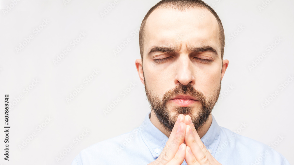 Bearded man praying hard, religious man, copy space, portrait, white background, close-up, 16:9
