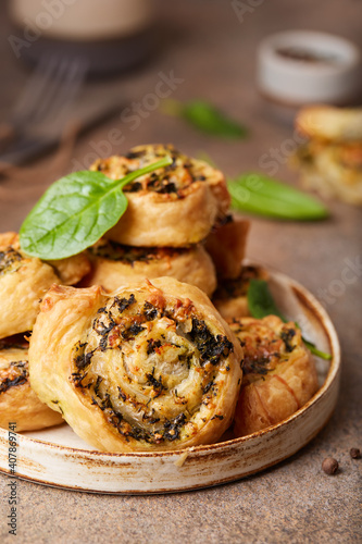 Delicious homemade puff pastry Pizza rolls with spinach, chicken meat and cheese 