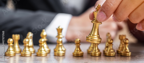businessman holding Gold Chess King figure. Strategy, Success, management, business planning, tactic, politic, thinking, vision and leadership concept