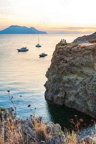 Ankernde Yachten im Abendlicht am Capo Milazzese photo