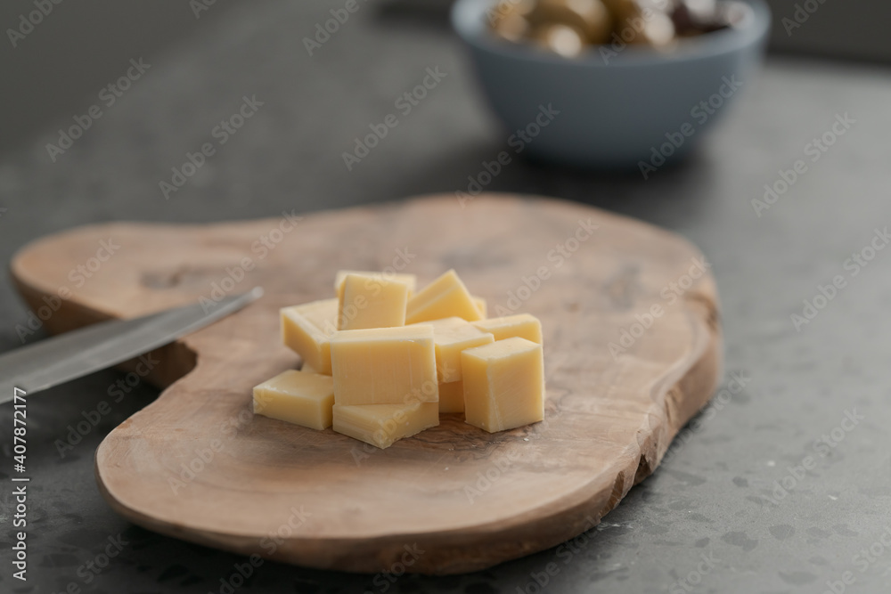 Pieces of hard vintage cheese on wood olive board