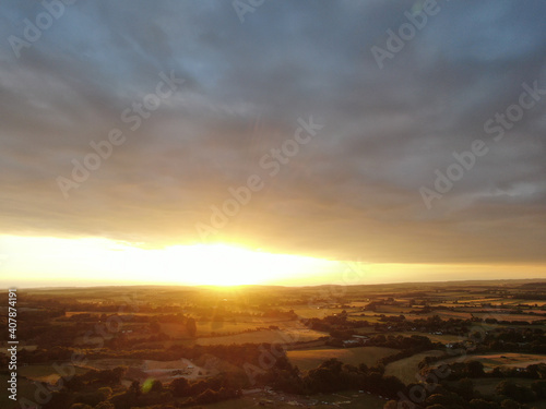 aerial view of beautiful rolling countryside at sunset with a golden light © chris