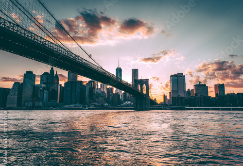 Cable-stayed Brooklyn Bridge and New York City skyline with modern high-rise buildings at twilight photo