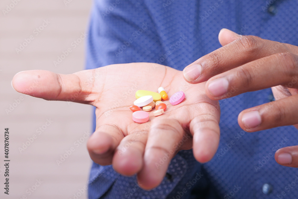 Close up of man hand holding pills and capsule with copy space Close up of man hand holding pills and capsule with copy space