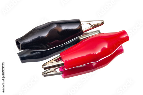 Red and black crocodile clips isolated on white background
