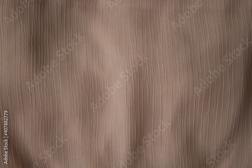 The texture of a luxurious beige chiffon fabric for a celebration, advertising poster, ceremony or invitation card, background