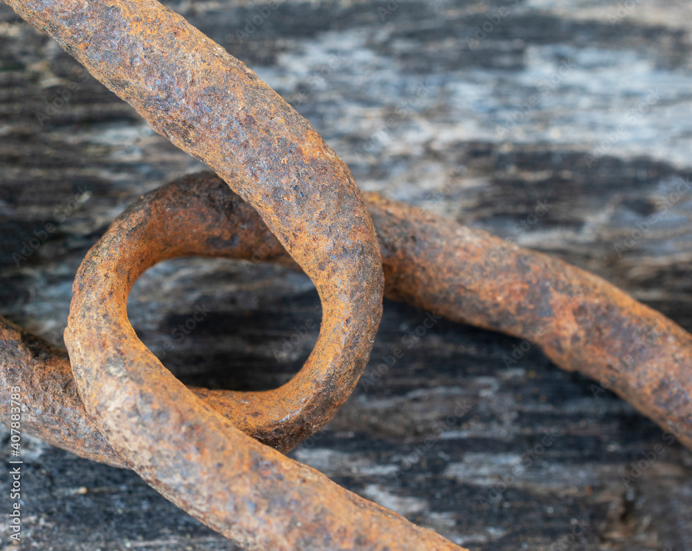 Rustic iron chain rings on wooden background. Rustic iron chain rings on wooden background.