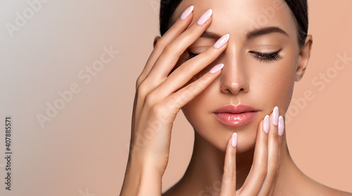 Beautiful girl hand care  . Model woman showing  french  shellac manicure on nails   . Cosmetics ,beauty and makeup photo