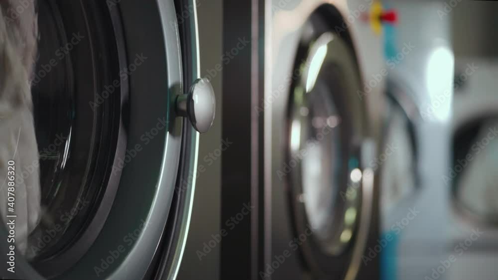 washing machine and dryer working at professional industrial laundry