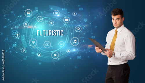 Businessman thinking in front of technology related icons and FUTURISTIC inscription, modern technology concept