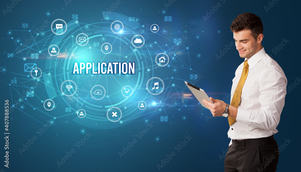Businessman thinking in front of technology related icons and APPLICATION inscription, modern technology concept Businessman thinking in front of technology related icons and APPLICATION inscription, modern technology concept