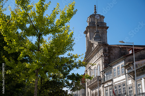 São Pedro Basilica. Old church made of rock. Tree in the foreground and blue sky.
