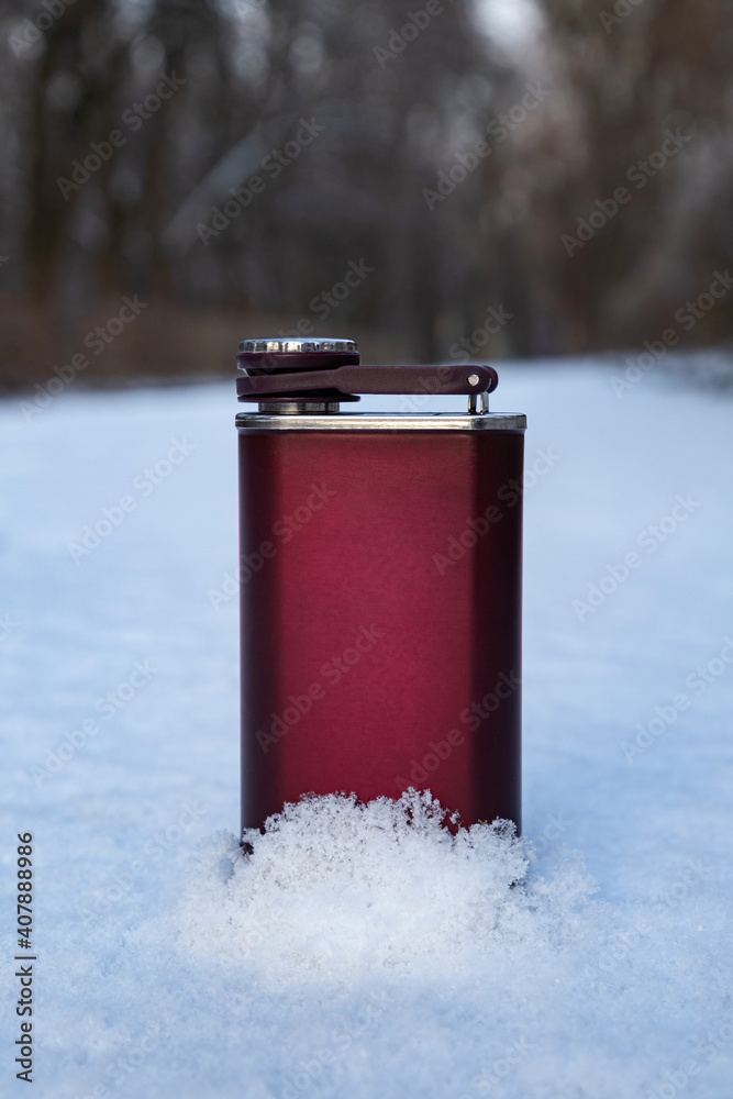 Steel alcohol flask in the winter forest. men's accessory for alcohol. Steel alcohol flask in the winter forest. men's accessory for alcohol.