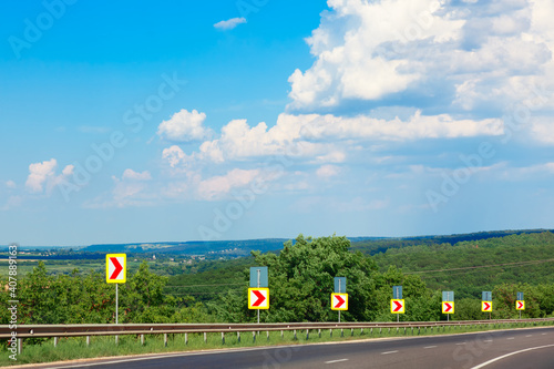 Road signs turning direction. Driving on an asphalt road . Traveling by car