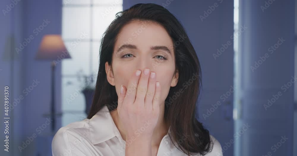 Beauty shot of young happy woman with perfect face skin after applying moisturizing cream is sending air kiss and smiling in camera. Concept of skincare, cosmetics, healthy lifestyle, wellness. Beauty shot of young happy woman with perfect face skin after applying moisturizing cream is sending air kiss and smiling in camera. Concept of skincare, cosmetics, healthy lifestyle, wellness.
