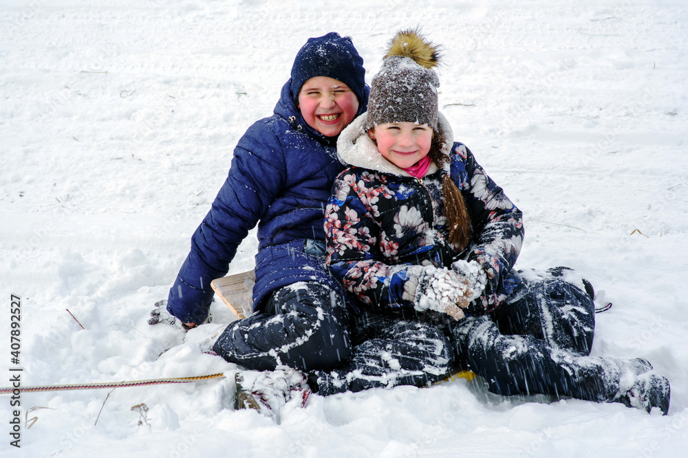 European kids play under snow fall.Fun. European kids play under snow fall.Fun.